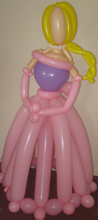 Life sized balloon princess with yellow hair and a purple and pink dress