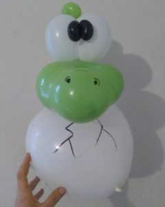 Baby dinosaur balloon hatching from a balloon egg twisted for kids events