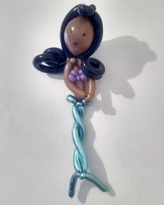 Brown mermaid balloon with black hair made out of twisted balloons. 