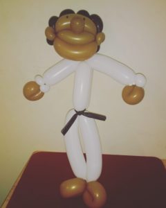 Brown karate kid twisted balloon wearing a black belt for a children's event