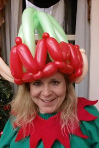 Green and red elf balloon hat twisted for a Christmas party