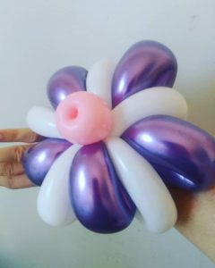 Twisted white and purple chrome balloon flower with a pink center for an event
