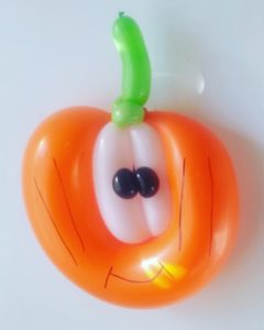 Pumpkin balloon with large eyes twisted for Halloween