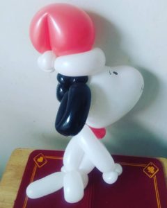Snoopy balloon with a red Santa Claus hat