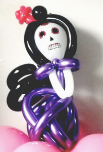 Sugar skull balloon girl with a twisted purple chrome dress balloon for Day of the Dea/dia de los Muertes