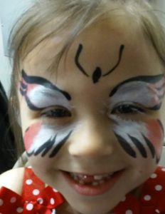 Girl with white and pink butterfly face painting design