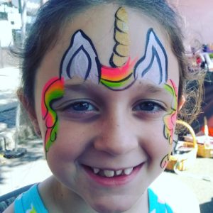 Unicorn face painting at a children's event