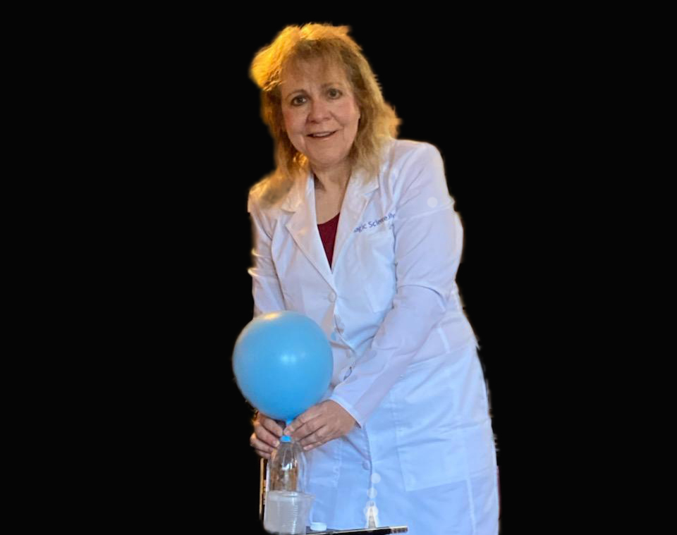 Wendy the Wacky scientist in her scientist robe performing a science experiment with a balloon and soda and vinegar