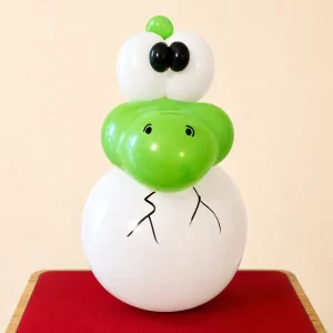 Balloon dinosaur hatching from an egg created by a Long Island balloon twister.