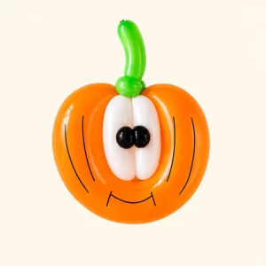Orange pumpkin balloon sculpture created by a Long Island balloon twister.