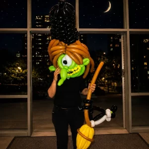 Balloon witch mask and broom created by a Long Island balloon twister