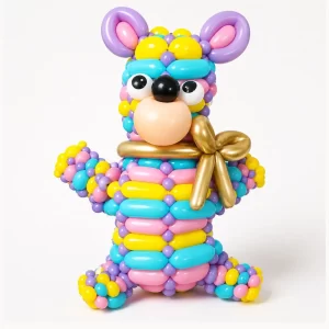 Colorful rainbow teddy bear balloon sculpture by a Long Island balloon twister.